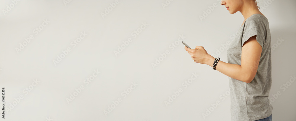 Poster beautiful hipster woman checking email via mobile phone while background with copy space for text me