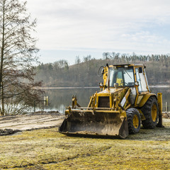 Excavator on the lake.