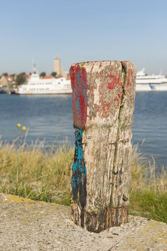 Old weathered and beautifully colored mooring pole.