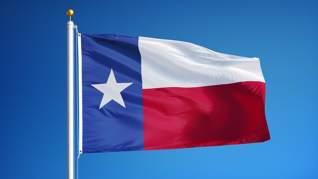Texas flag waving in slow motion against clean blue sky, seamlessly looped, close up, isolated on alpha channel with black and white luminance matte, perfect for film, news, digital composition