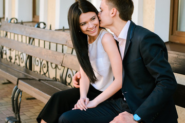 Couple kissing happiness fun. Interracial young couple embracing laughing on date.