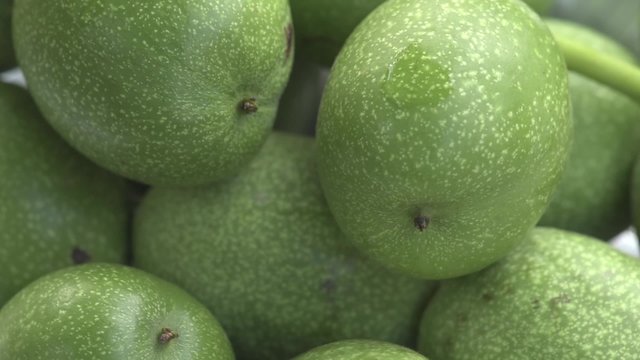 Green nuts closeup rotation in daylight