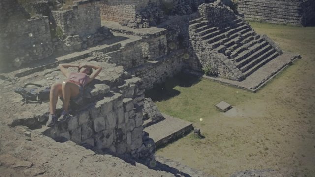 Hispanic woman resting over pyramids in summer day