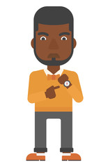 Angry boss pointing at wrist watch.