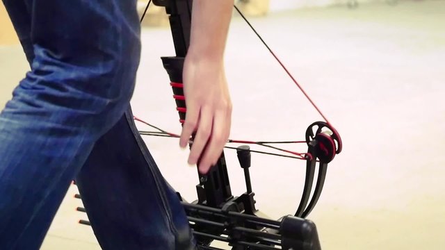 Handsome man with a bow and arrowss shoots with a crossbow in the dash in slowmotion. 1920x1080