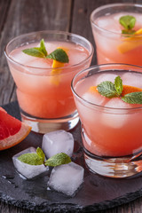 Grapefruit cocktail with ice and mint.