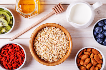 Healthy breakfast - bowl of oat flakes with fresh fruit, almond