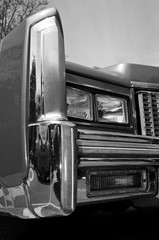 Detail of a vintage car light in black and white