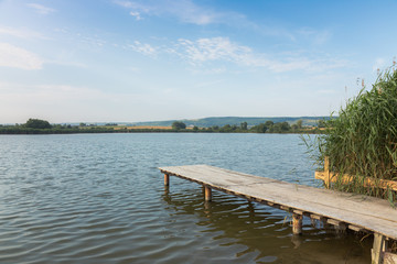 Wooden board on morning lake
