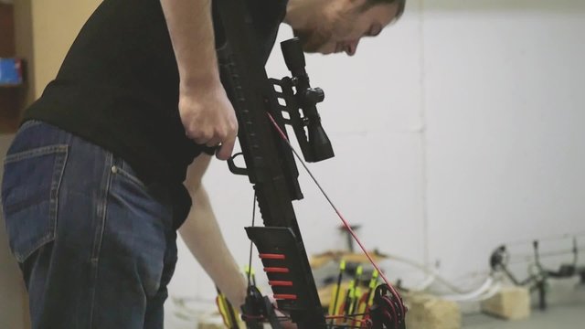 Handsome man with a bow and arrowss hoots with a crossbow in the dash in slowmotion. 1920x1080