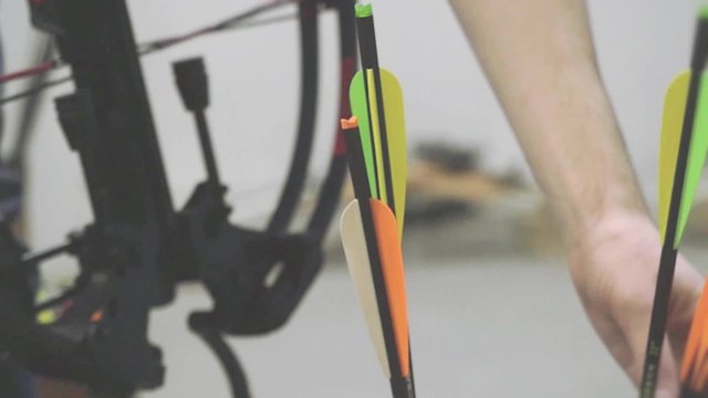 Handsome man with a bow and arrowss hoots with a crossbow in the dash in slowmotion. 1920x1080