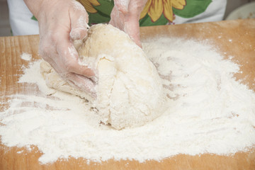 Women's hands preparing fresh yeast dough