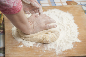 Women's hands preparing fresh yeast dough