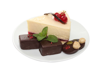 Cheese Cake with chocolate candies and mint leaf
