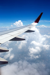   Above the clouds.Wing aircraft in the sky under earth of Thailand