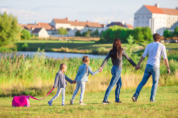 Happy family with baggage ready for traveling outdoors