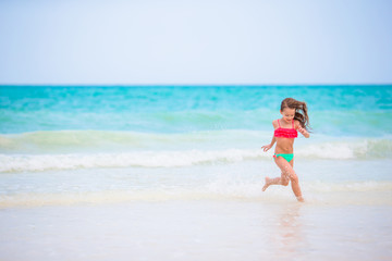 Fototapeta premium Adorable little girl at beach during summer vacation