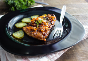 pieces of fried fish in a plate with pickles