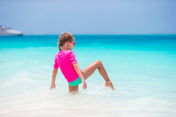 Adorable little girl during beach vacation having fun
