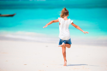 Adorable little girl at beach during summer vacation