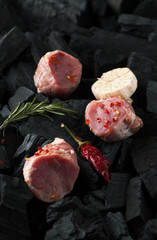 Raw pork medallions with rosemary and garlic