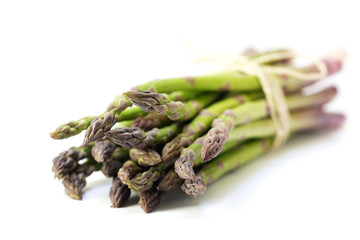 bunch of green asparagus isolated on a white background, closeup