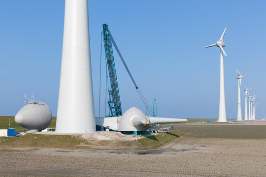 Dutch farmland with construction site ner wind turbines