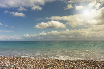 Beautiful sea paradise beach on a background of blue sky with clouds.