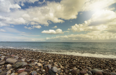 Fototapeta na wymiar Beautiful sea paradise beach on a background of blue sky with clouds.