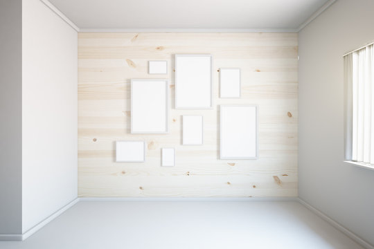 Light wooden wall with frames