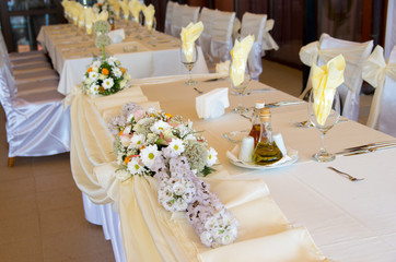 Table decoration for festive celebration with flowers.