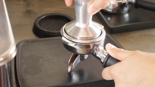 Barista work with tamper and portafilter making espresso, stock video