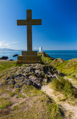 Cross and lighthouse on Llanddwyn Island, Anglesey