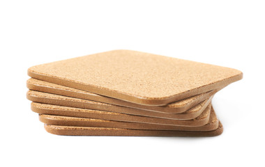 Pile of cork textured coasters isolated