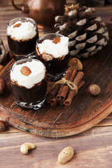 hot chocolate in glass cups and cream with nuts