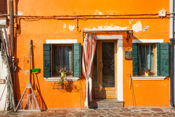 Detail of a traditional orange house in Burano island, Venice