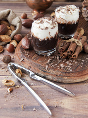 hot chocolate in glass cups and cream with nuts