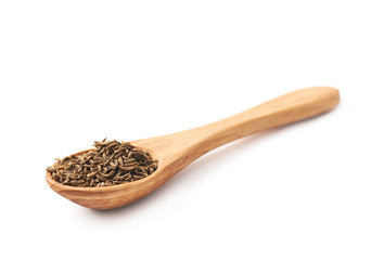 Wooden spoon full of cumin seeds
