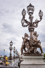 Fototapeta na wymiar Pont Alexandre III bridge Paris with cherubs statue and lanterns