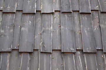 Texture of large clapboard roof on wooden historical cabin
