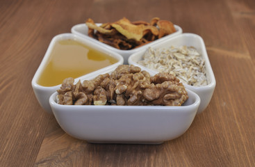 breakfast foods: nuts, honey, fruit. selective focus