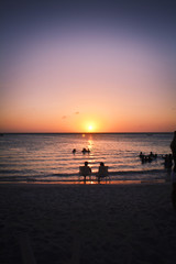 Fototapeta premium People enjoying a sunset on the beach