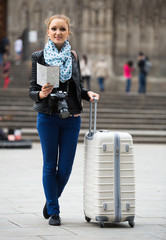 Girl with baggage and city map.