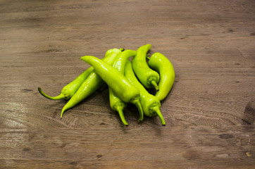 green peppers on wood table
