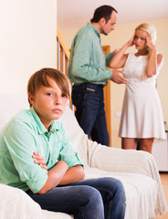 Obraz premium Adults quarrel and sad boy