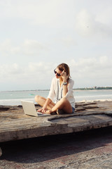 Outdoor portrait of young writer/blogger/freelancer/student with laptop