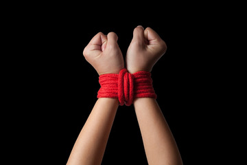 Hands of a missing kidnapped, abused, hostage, victim woman tied up with rope in emotional stress and pain, afraid, restricted, trapped, call for help, struggle, terrified.