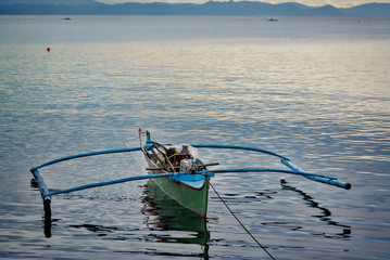 Fishing boat on a lake at dawn on Poliqui Bay, Legazpi City, Philippines