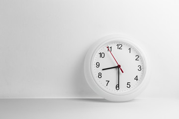 White circle clock with white wall