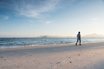 silhouette running on the island beach